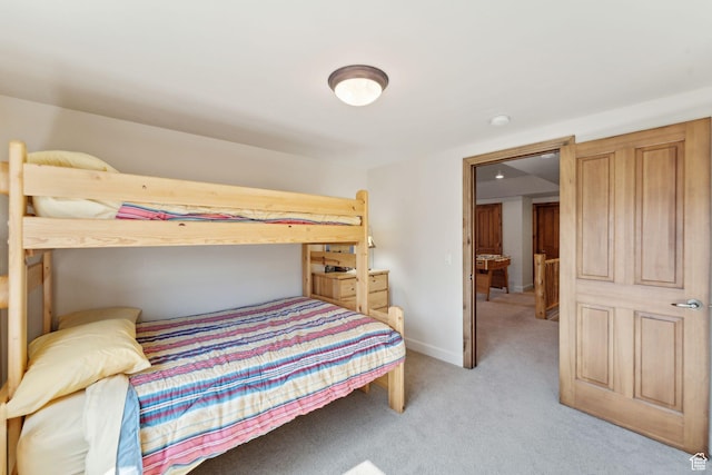 bedroom featuring light carpet and baseboards