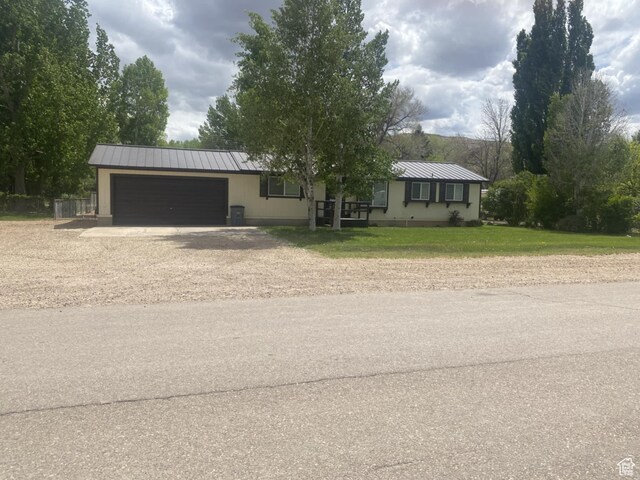 250 W 100 S, Duchesne, UT 84021 - ranch-style house with an attached garage, dirt driveway, metal roof, and a standing seam roof