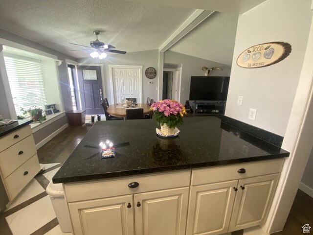 250 W 100 S, Duchesne, UT 84021 - kitchen with ceiling fan, dark stone countertops, a textured ceiling, vaulted ceiling, and white cabinetry