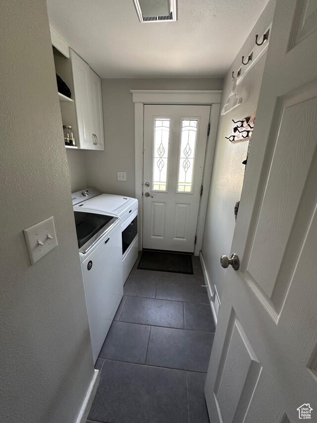 250 W 100 S, Duchesne, UT 84021 - washroom featuring cabinet space, washing machine and clothes dryer, dark tile patterned floors, and baseboards