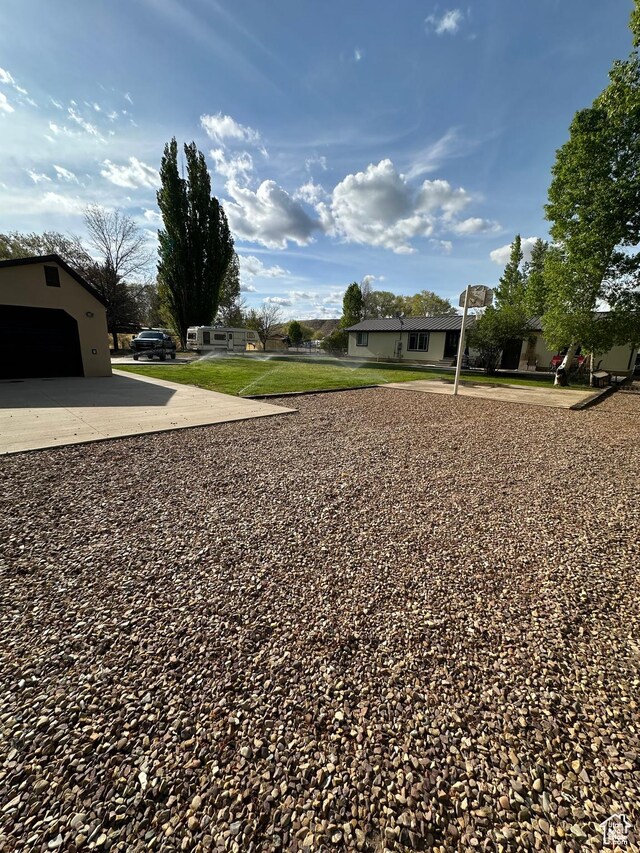 250 W 100 S, Duchesne, UT 84021 - view of green lawn with concrete driveway and a garage
