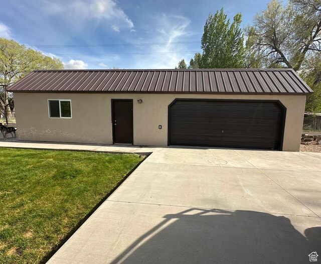 250 W 100 S, Duchesne, UT 84021 - view of front of home featuring stucco siding, a front yard, a garage, and metal roof