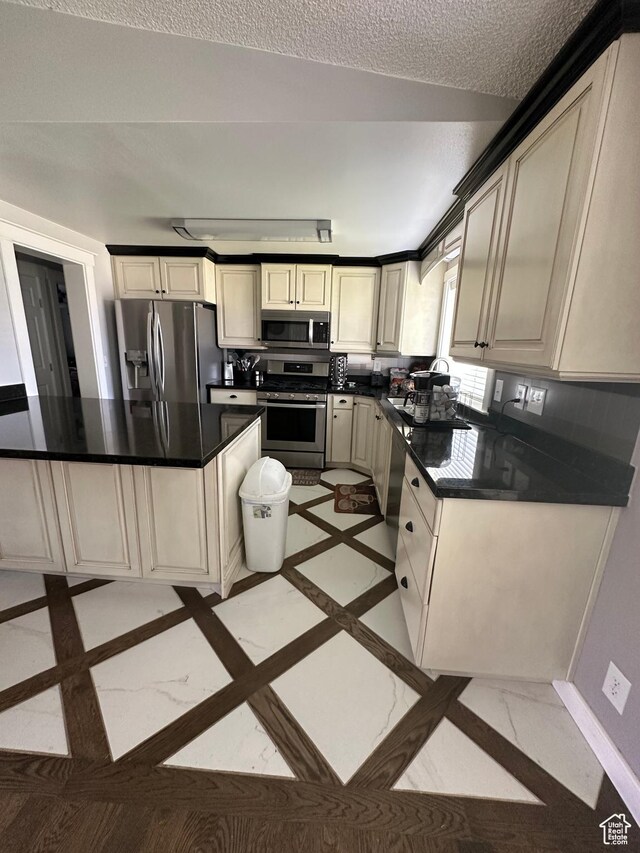 250 W 100 S, Duchesne, UT 84021 - kitchen featuring appliances with stainless steel finishes, dark countertops, and inlaid floor details
