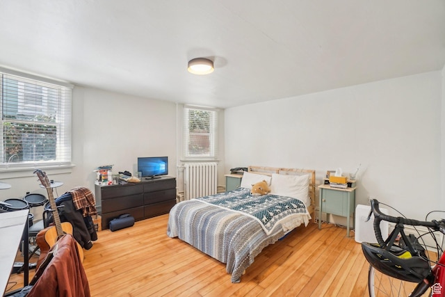 bedroom with light wood-type flooring and radiator
