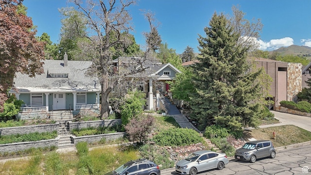 obstructed view of property with stairs and a porch