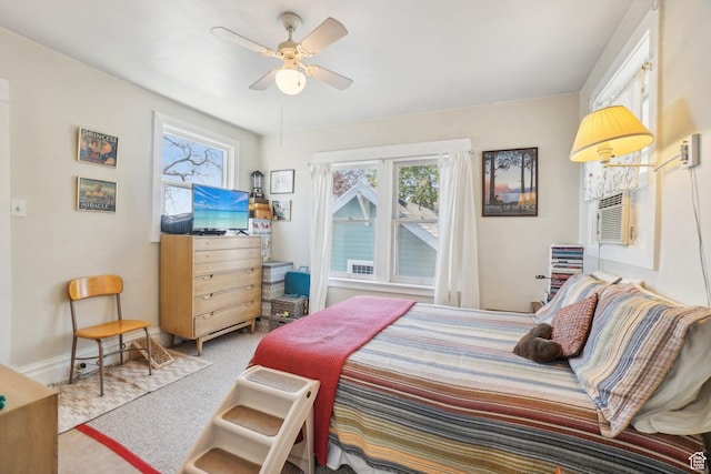 carpeted bedroom with ceiling fan and baseboards