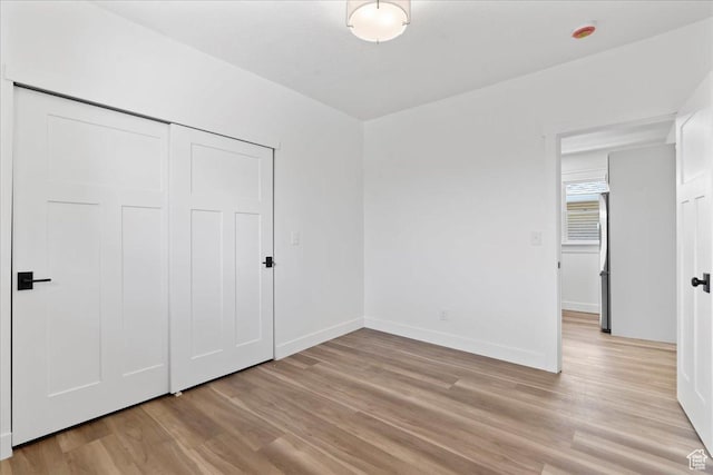 328 E Hampton Ave S, Salt Lake City, UT 84111 - unfurnished bedroom with light wood finished floors, stainless steel refrigerator, and a closet