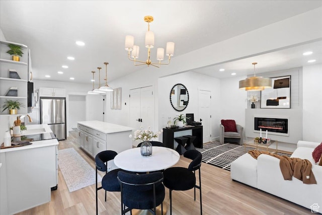 328 E Hampton Ave S, Salt Lake City, UT 84111 - dining area featuring light wood-style flooring, recessed lighting, a glass covered fireplace, and a chandelier
