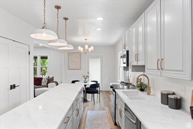 328 E Hampton Ave S, Salt Lake City, UT 84111 - kitchen with appliances with stainless steel finishes, light wood-type flooring, pendant lighting, recessed lighting, and light stone countertops