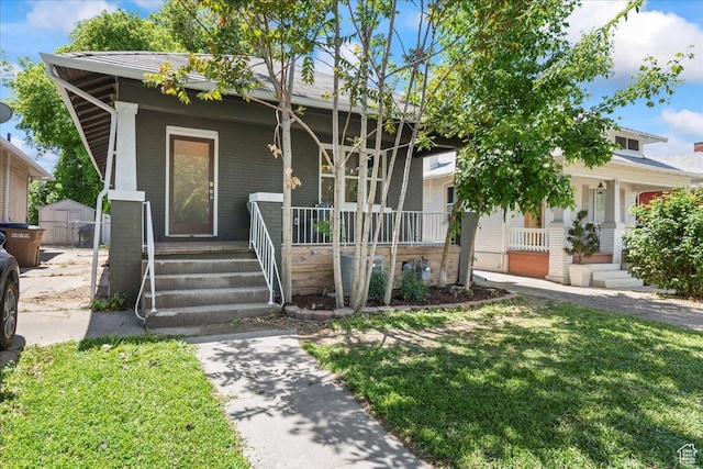 328 E Hampton Ave S, Salt Lake City, UT 84111 - view of front of property featuring covered porch, a storage unit, and a front yard