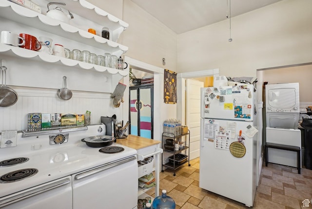 538 S 800 E, Salt Lake City, UT 84102 - kitchen featuring white appliances, stone tile floors, and stacked washer / drying machine