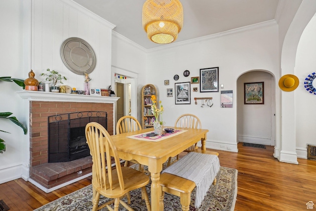 538 S 800 E, Salt Lake City, UT 84102 - dining room with arched walkways, hardwood / wood-style floors, ornamental molding, a fireplace, and baseboards