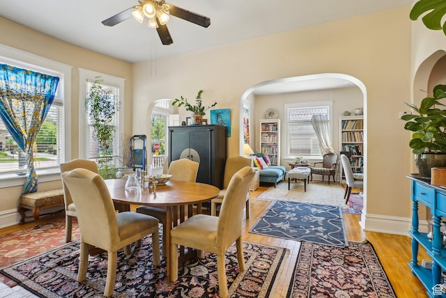 538 S 800 E, Salt Lake City, UT 84102 - dining area featuring ceiling fan, arched walkways, light wood-style flooring, and baseboards