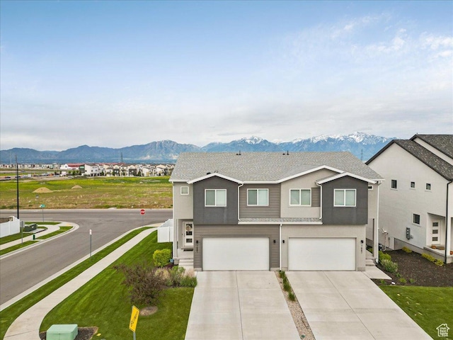 7881 S Highlandpoint Way, West Jordan, UT 84081 - view of front facade featuring a mountain view, a garage, concrete driveway, and a front lawn
