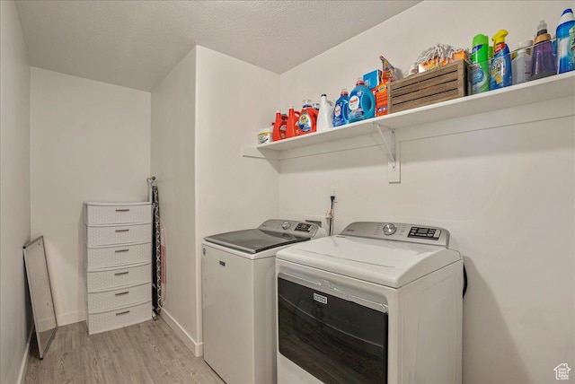 7881 S Highlandpoint Way, West Jordan, UT 84081 - clothes washing area featuring separate washer and dryer, light wood-style floors, baseboards, and a textured ceiling