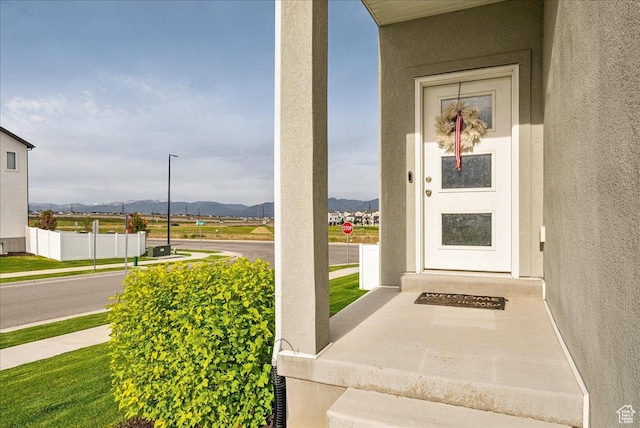 7881 S Highlandpoint Way, West Jordan, UT 84081 - doorway to property with a mountain view and stucco siding