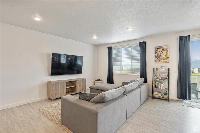 7881 S Highlandpoint Way, West Jordan, UT 84081 - living room with light wood-type flooring, healthy amount of natural light, baseboards, a textured ceiling, and recessed lighting