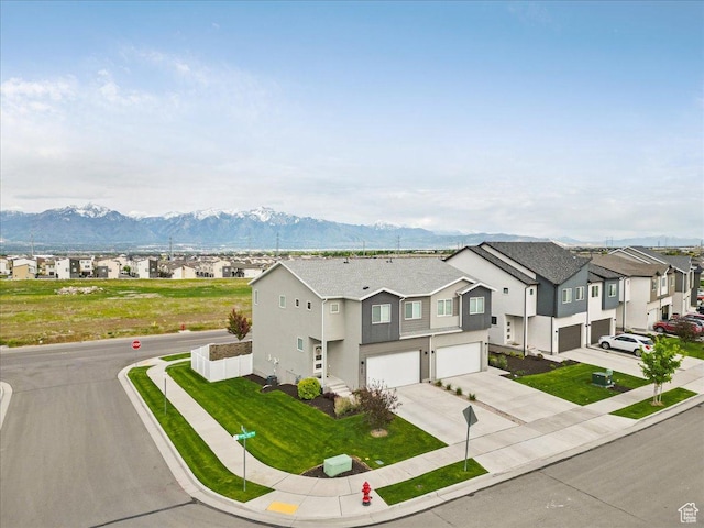 7881 S Highlandpoint Way, West Jordan, UT 84081 - view of front of home featuring an attached garage, driveway, a residential view, stucco siding, and a mountain view