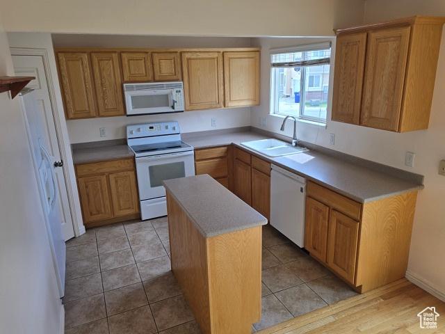 834 N Sapphire St, Morgan, UT 84050 - kitchen with white appliances, a sink, a kitchen island, and light countertops