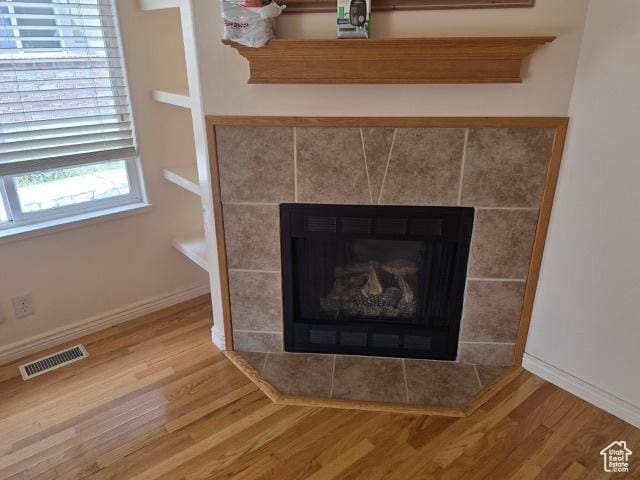 834 N Sapphire St, Morgan, UT 84050 - detailed view of wood finished floors, baseboards, and a fireplace