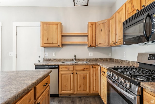 kitchen featuring stainless steel appliances, a sink, dark wood-style floors, open shelves, and dark countertops