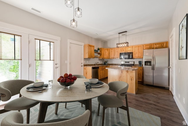 dining area featuring dark wood finished floors and baseboards