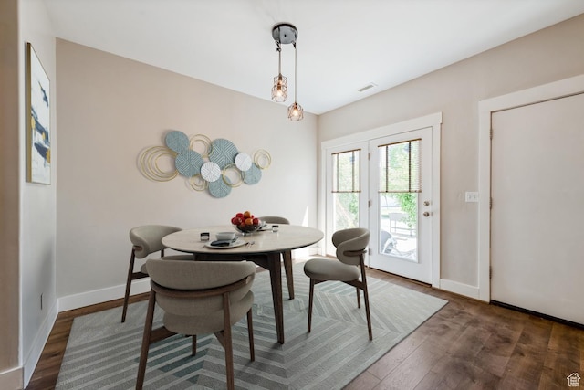 dining room featuring wood finished floors and baseboards