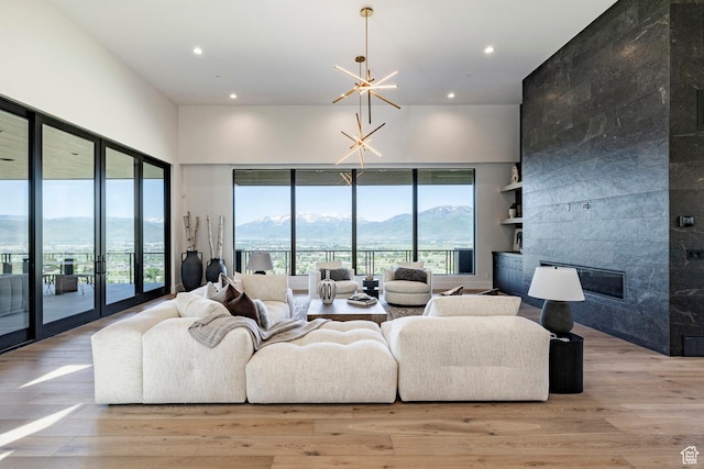 1964 E Upper Lookout Knoll Cir Unit 371, Heber City, UT 84032 - living room featuring a mountain view, recessed lighting, light wood finished floors, a chandelier, and a tile fireplace