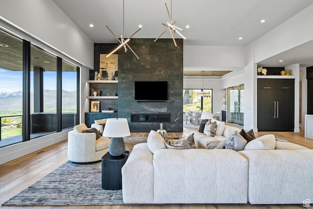 living area featuring recessed lighting, wood finished floors, and a fireplace