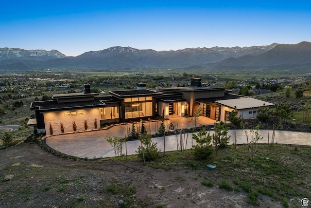 1964 E Upper Lookout Knoll Cir Unit 371, Heber City, UT 84032 - rear view of house with a chimney, a mountain view, and driveway