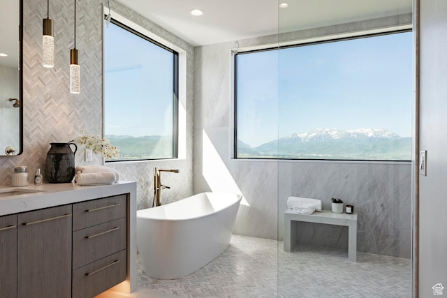 1964 E Upper Lookout Knoll Cir Unit 371, Heber City, UT 84032 - bathroom featuring tile walls, a freestanding tub, vanity, tile patterned flooring, and decorative backsplash