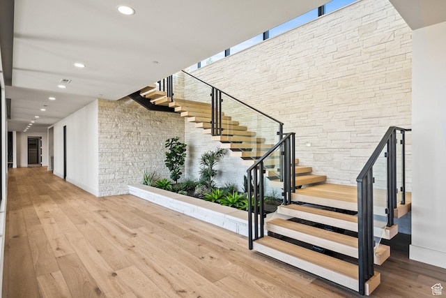 stairs with hardwood / wood-style floors, recessed lighting, and baseboards