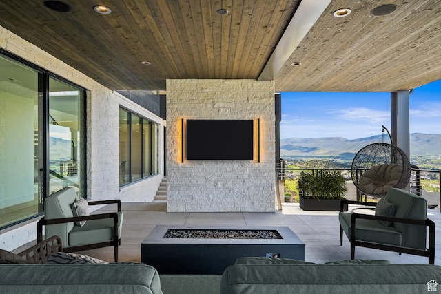 view of patio featuring an outdoor living space with a fire pit