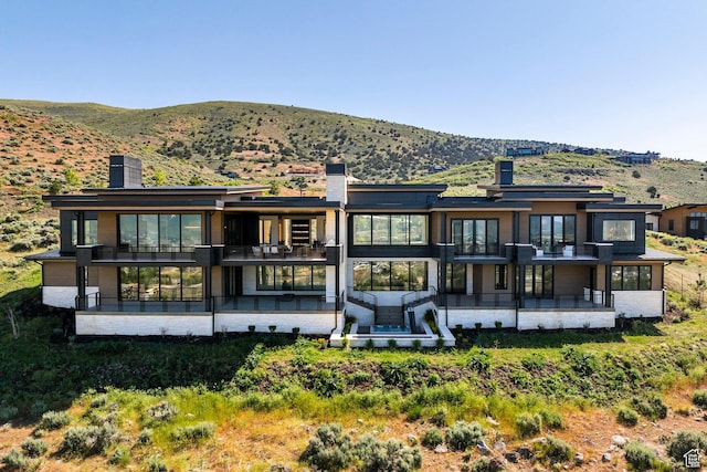 1964 E Upper Lookout Knoll Cir Unit 371, Heber City, UT 84032 - back of property with a chimney, a mountain view, a balcony, and a patio area