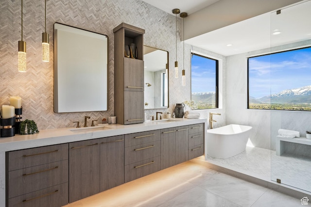 bathroom featuring a freestanding tub, double vanity, and decorative backsplash