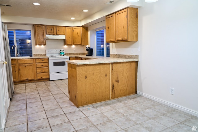 15059 S Rose Creek Ln, Herriman, UT 84096 - kitchen with electric range, under cabinet range hood, a peninsula, recessed lighting, and brown cabinets