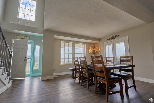 15059 S Rose Creek Ln, Herriman, UT 84096 - dining space with a textured ceiling, stairway, dark wood-style flooring, healthy amount of natural light, and a chandelier