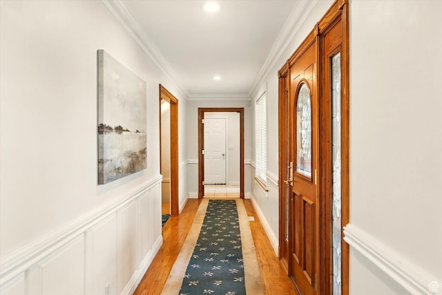 corridor with crown molding, light wood-style flooring, recessed lighting, and wainscoting
