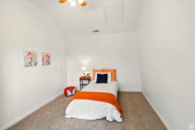 carpeted bedroom with vaulted ceiling, baseboards, attic access, and a ceiling fan