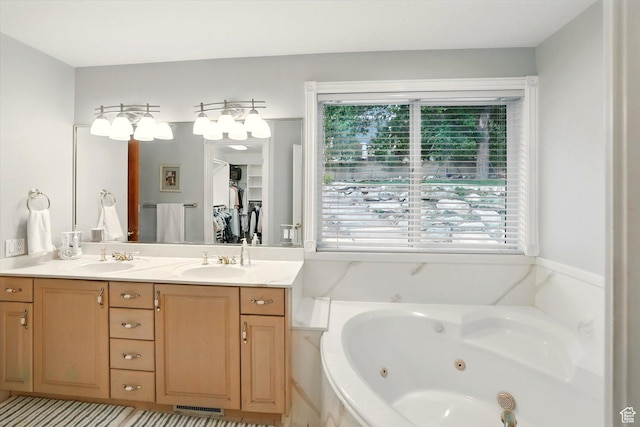full bathroom featuring plenty of natural light, a tub with jets, and double vanity