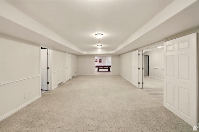 finished below grade area with light colored carpet and baseboards