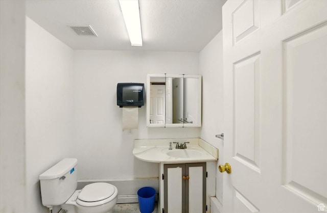 half bath featuring a sink, toilet, and baseboards