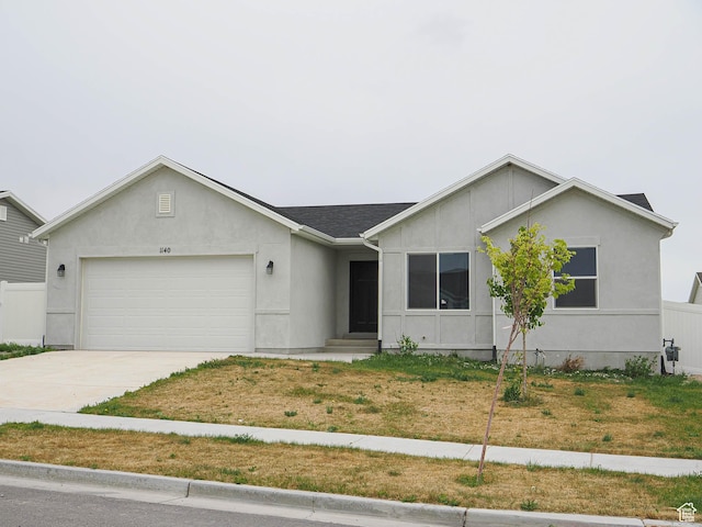 ranch-style house with an attached garage, driveway, and stucco siding