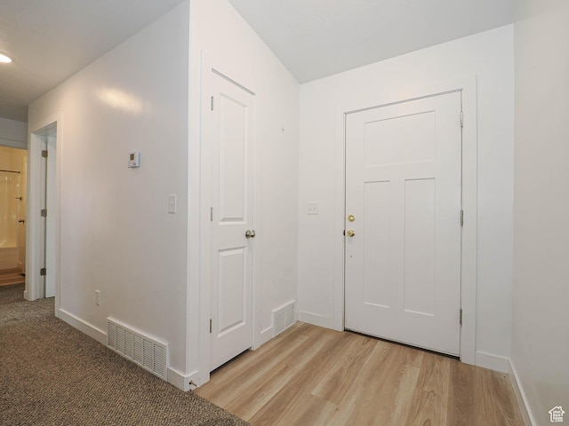 entryway with baseboards, light wood-style flooring, and recessed lighting