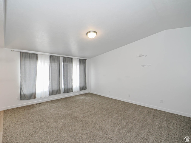 carpeted spare room with baseboards