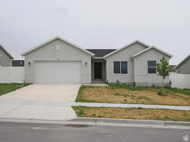 ranch-style house with a garage, fence, stucco siding, and concrete driveway