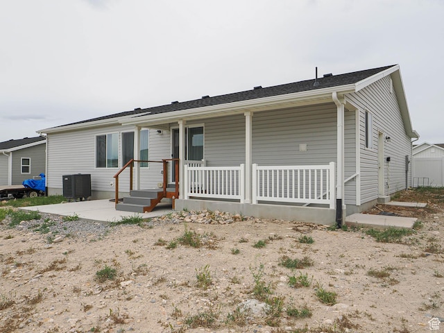 ranch-style home featuring a porch and central AC