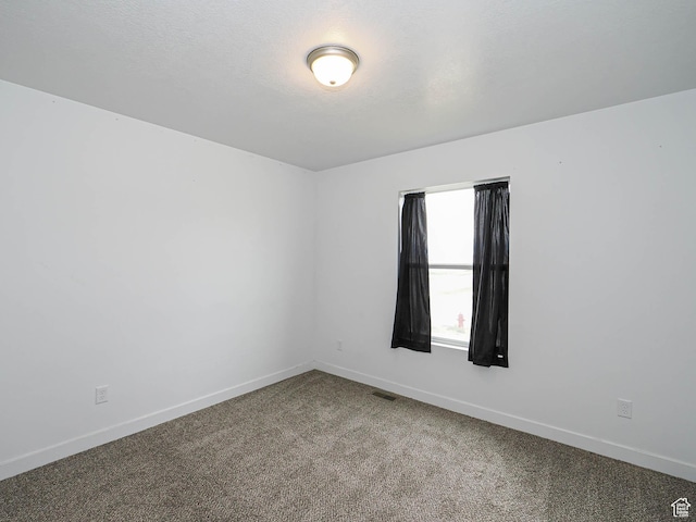 carpeted spare room with baseboards