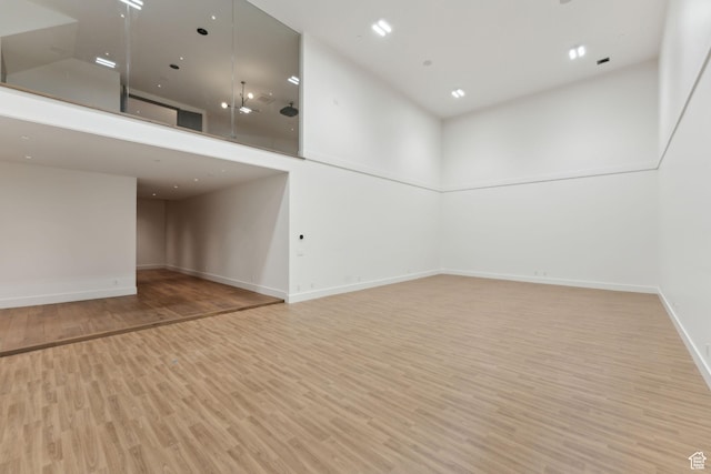 7455 N Promontory Ranch Rd, Park City, UT 84098 - empty room with wood finished floors, a high ceiling, and baseboards