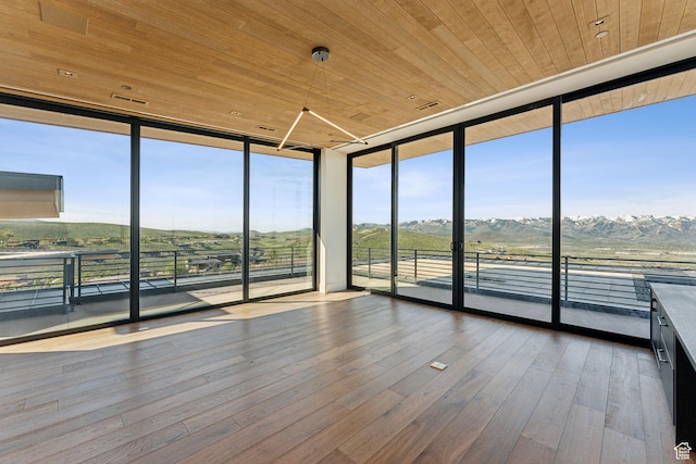 7455 N Promontory Ranch Rd, Park City, UT 84098 - unfurnished sunroom featuring expansive windows, wood ceiling, hardwood / wood-style floors, and a mountain view